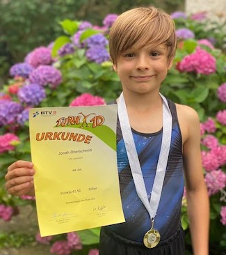 Turner mit Pokal und Urkunde